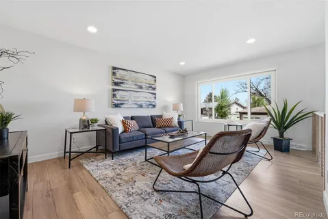 a living room with furniture and wooden floor