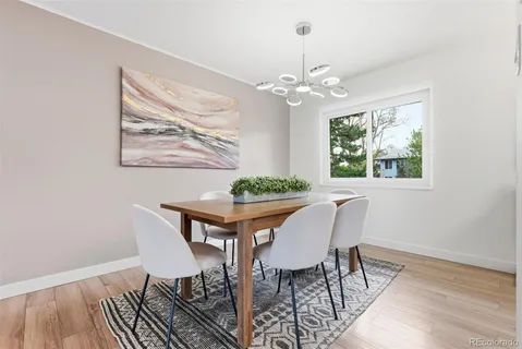 a view of a dining room with furniture window and wooden floor
