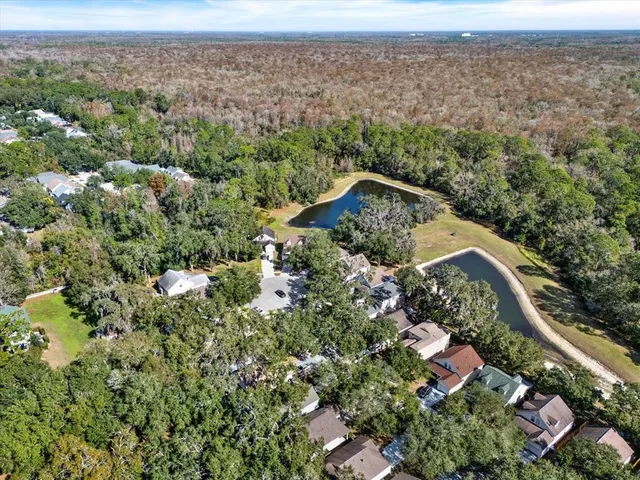 an aerial view of a house with a yard and lake view
