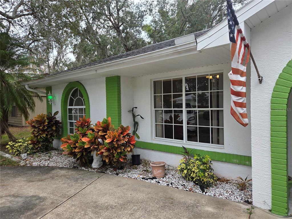 7605 Landmark Drive Spring Hill, FL 34606 - Photo 1 of 26 a front view of a house with garden