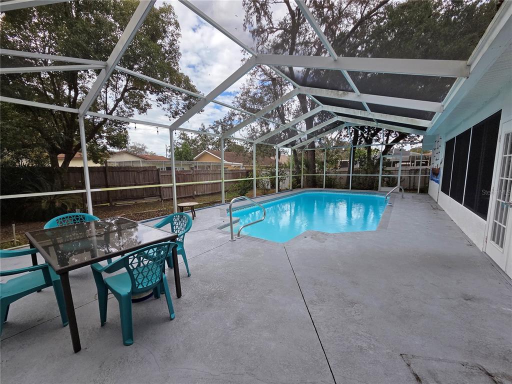 7605 Landmark Drive Spring Hill, FL 34606 - Photo 13 of 26 a view of a chairs and table in the patio