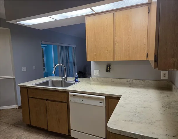 a kitchen with a sink and cabinets
