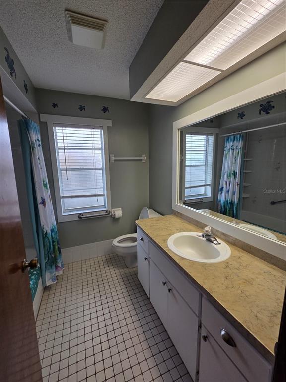 7605 Landmark Drive Spring Hill, FL 34606 - Photo 21 of 26 a spacious bathroom with a granite countertop sink a mirror and a bathtub