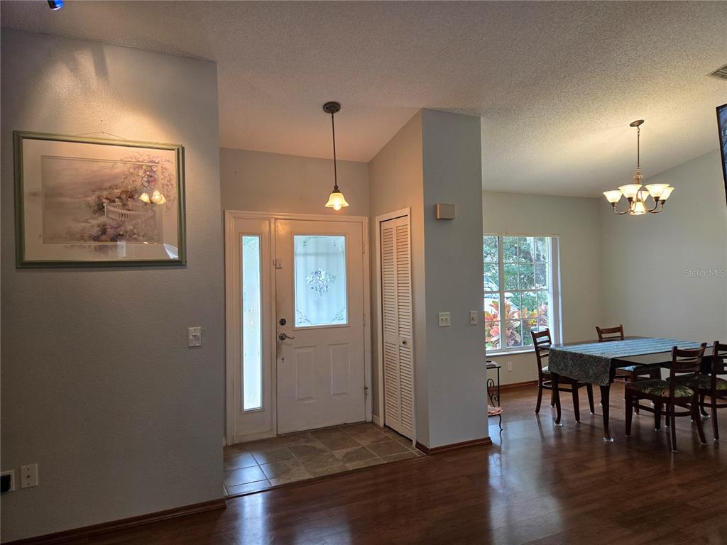 7605 Landmark Drive Spring Hill, FL 34606 - Photo 5 of 26 a view of a dining room with furniture window and wooden floor