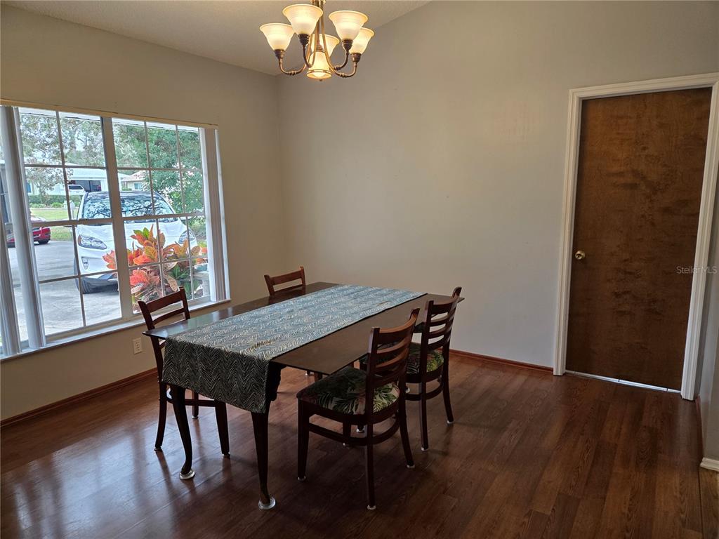 7605 Landmark Drive Spring Hill, FL 34606 - Photo 6 of 26 a view of a dining room with furniture window and wooden floor