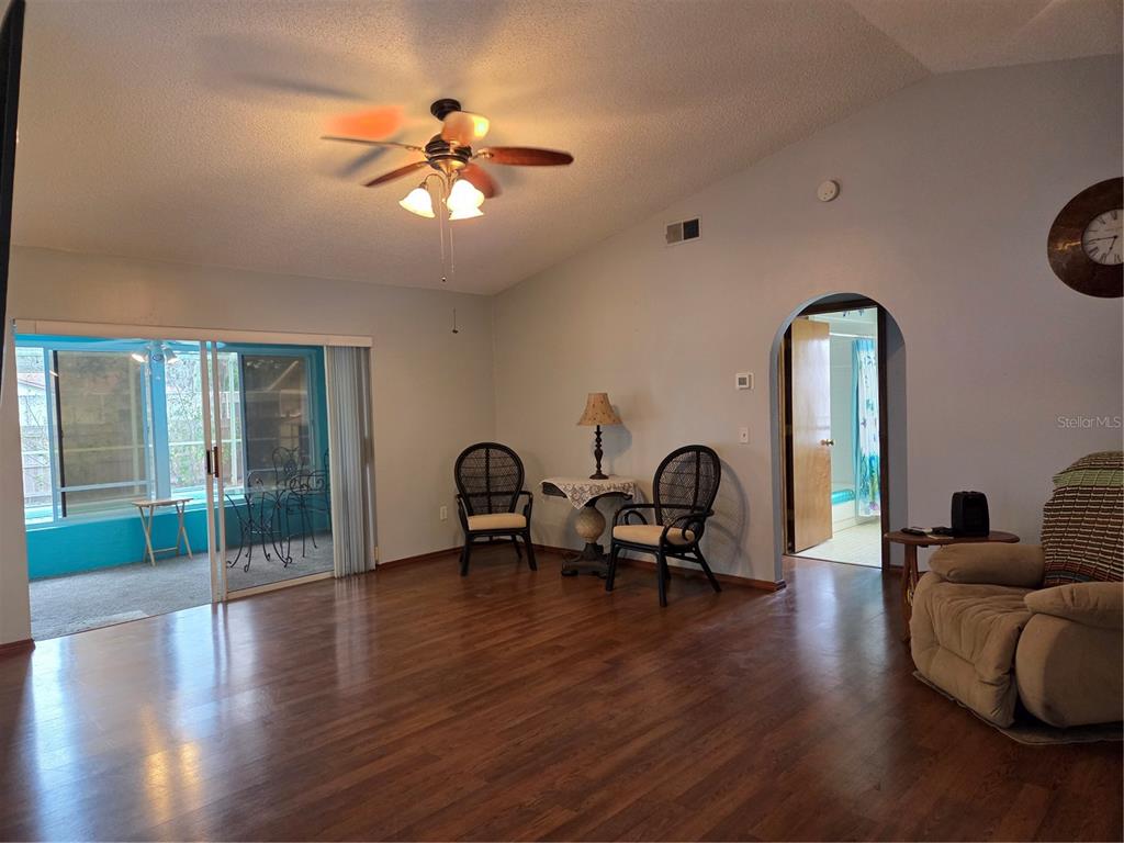 7605 Landmark Drive Spring Hill, FL 34606 - Photo 7 of 26 a living room with furniture two window and wooden floor