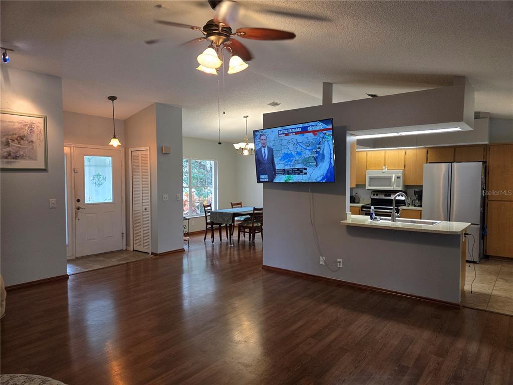 7605 Landmark Drive Spring Hill, FL 34606 - Photo 9 of 26 an open kitchen with furniture and a flat screen tv