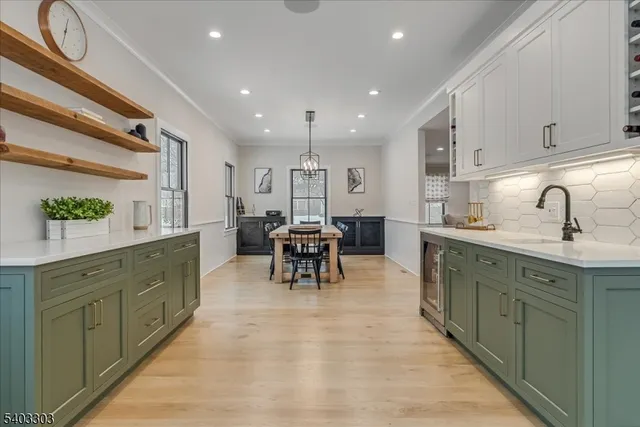 a bedroom with a bed flat screen tv and couches