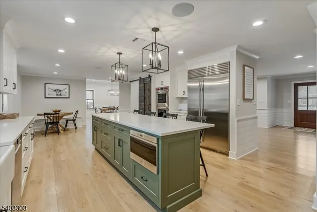 a kitchen with stainless steel appliances a sink a stove and cabinets