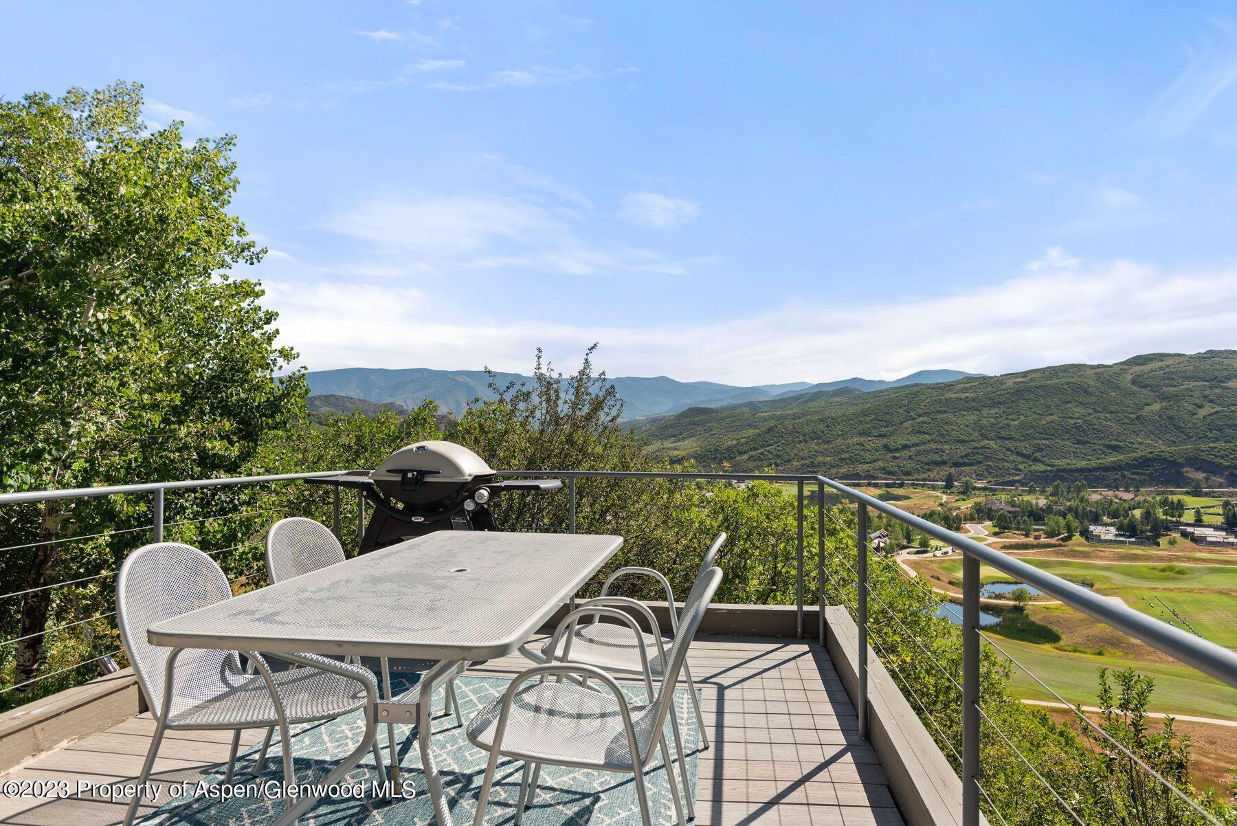 61 Oak Ridge Road Snowmass Village, CO 81615 - Photo 15 of 48 a balcony with wooden floor and city view