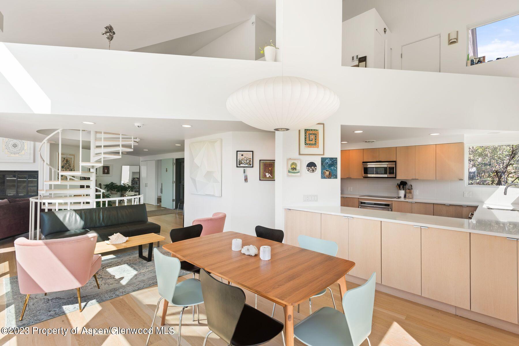 61 Oak Ridge Road Snowmass Village, CO 81615 - Photo 16 of 48 a open dining room with kitchen island a table and chairs in it