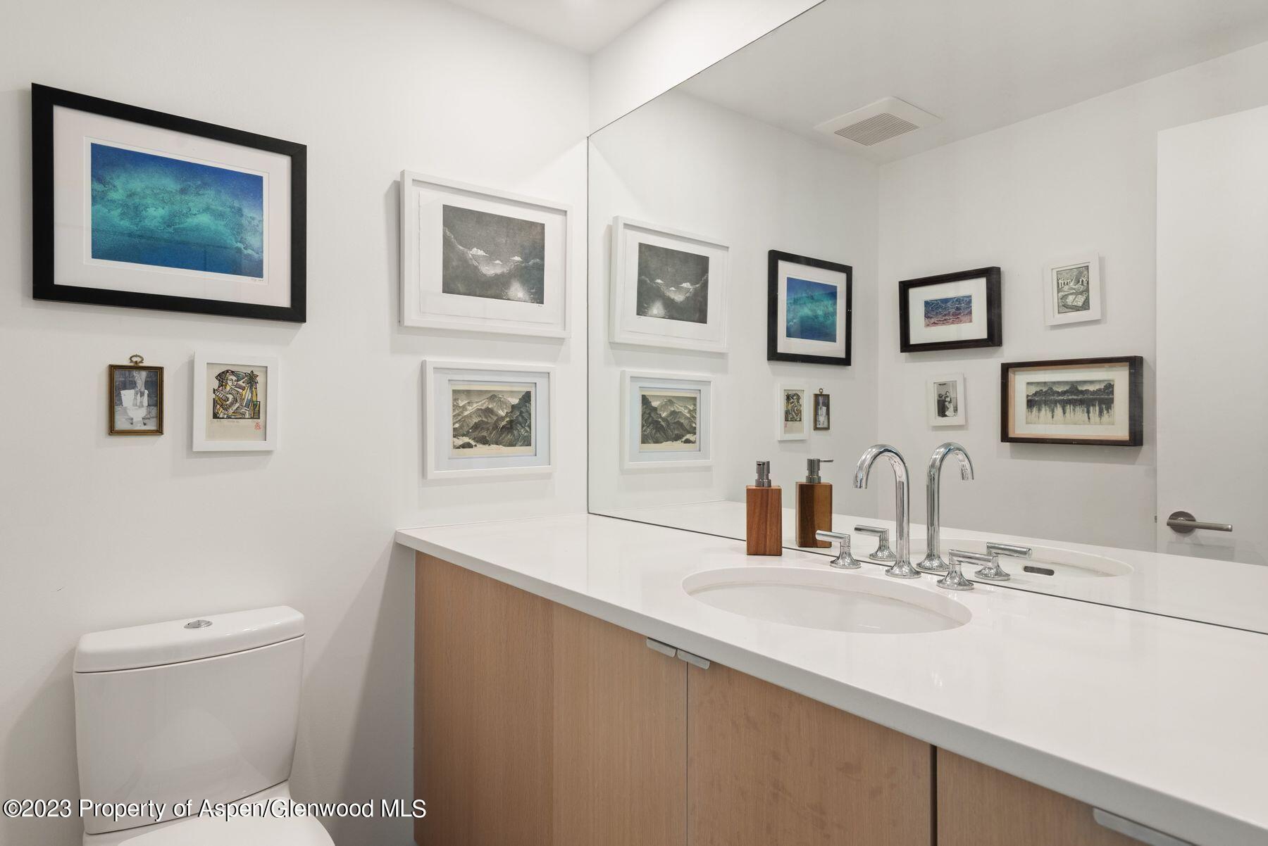 61 Oak Ridge Road Snowmass Village, CO 81615 - Photo 23 of 48 a bathroom with a sink mirror vanity and toilet
