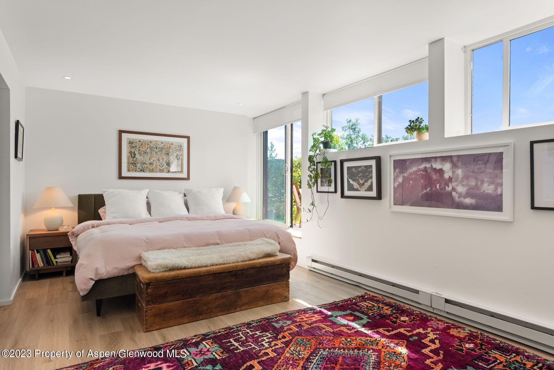 61 Oak Ridge Road Snowmass Village, CO 81615 - Photo 33 of 48 a bedroom with a bed and a painting on the wall