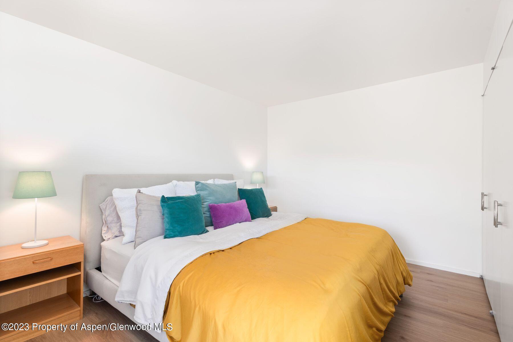 61 Oak Ridge Road Snowmass Village, CO 81615 - Photo 40 of 48 a bedroom with a bed and a night stand