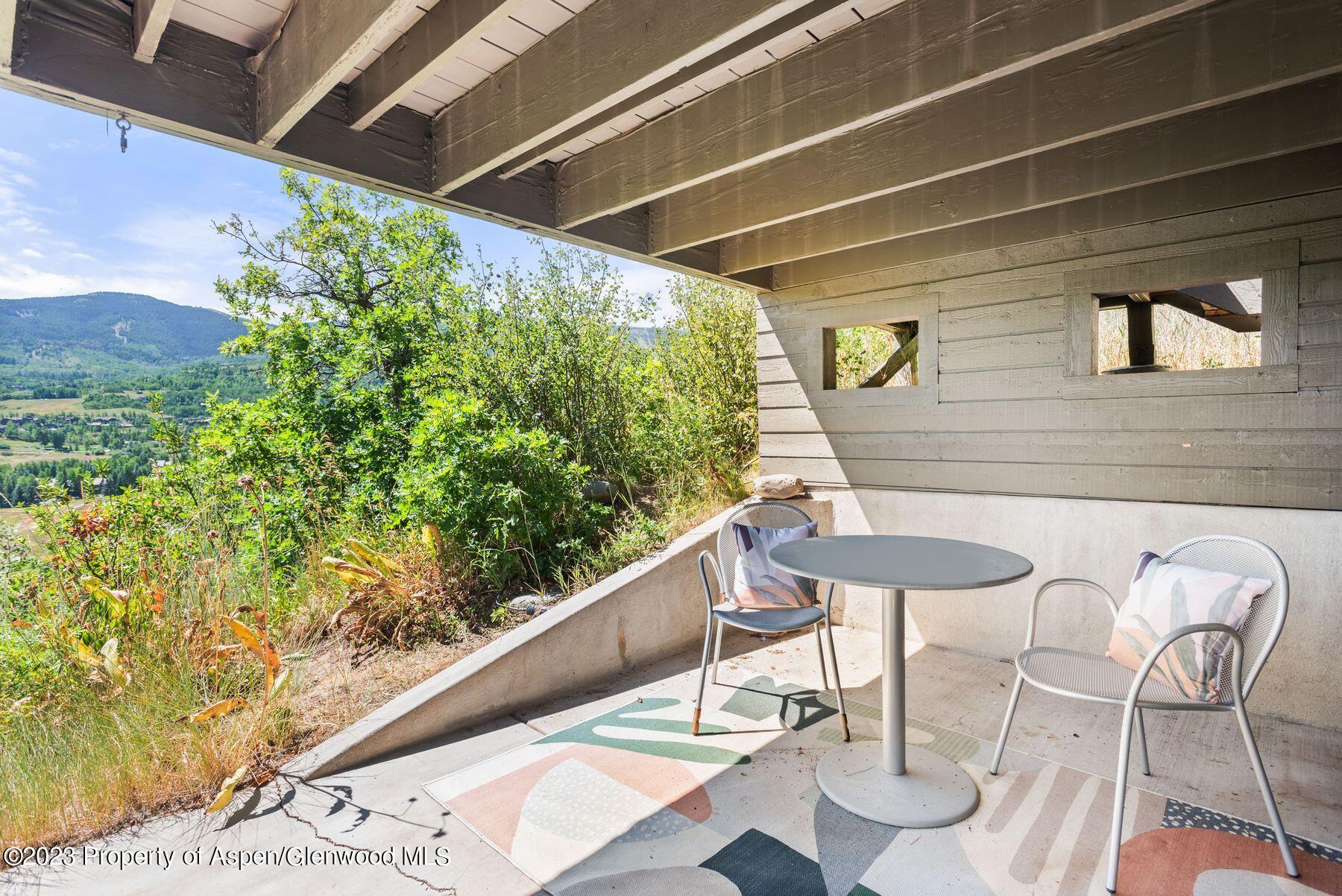 61 Oak Ridge Road Snowmass Village, CO 81615 - Photo 47 of 48 a balcony with table and chairs