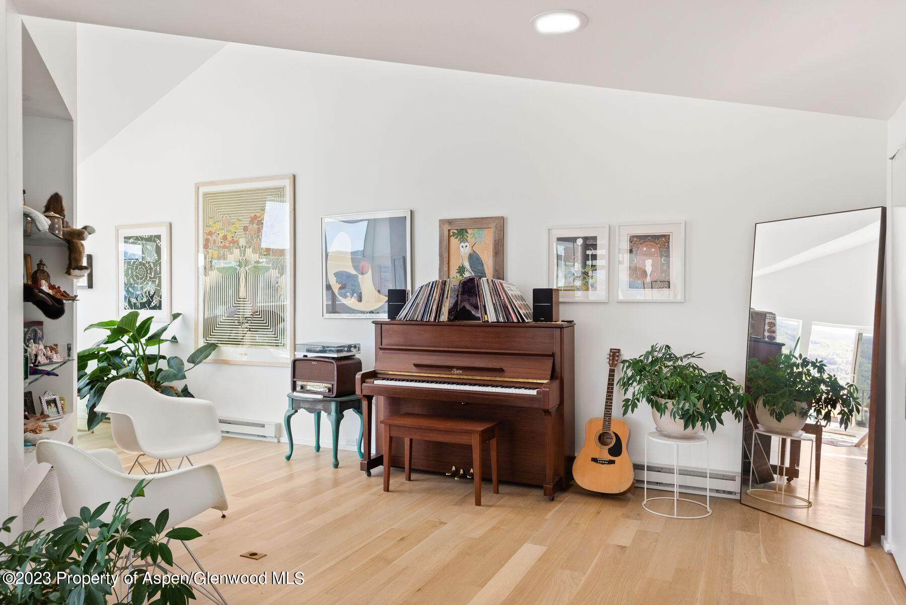 61 Oak Ridge Road Snowmass Village, CO 81615 - Photo 5 of 48 a living room with furniture a potted plant and a fireplace