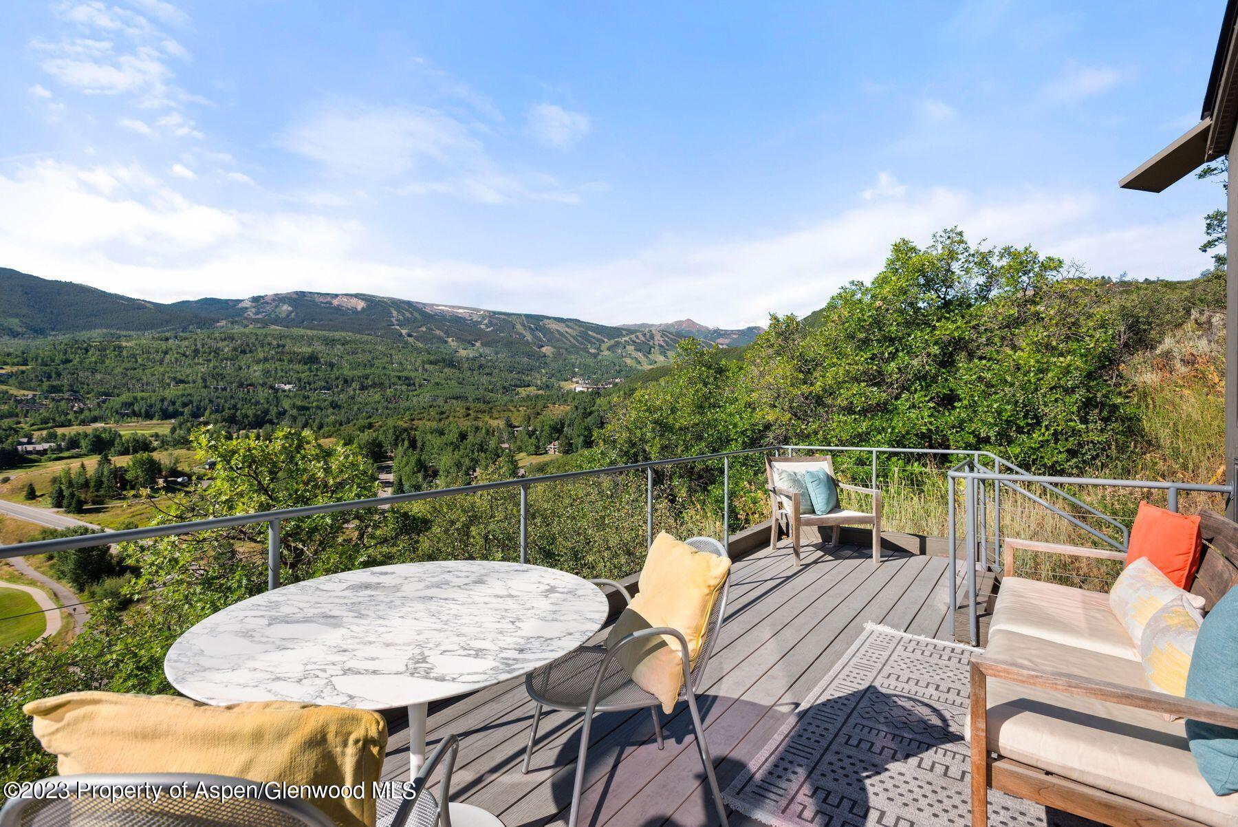 61 Oak Ridge Road Snowmass Village, CO 81615 - Photo 8 of 48 a view of a chairs and table in patio