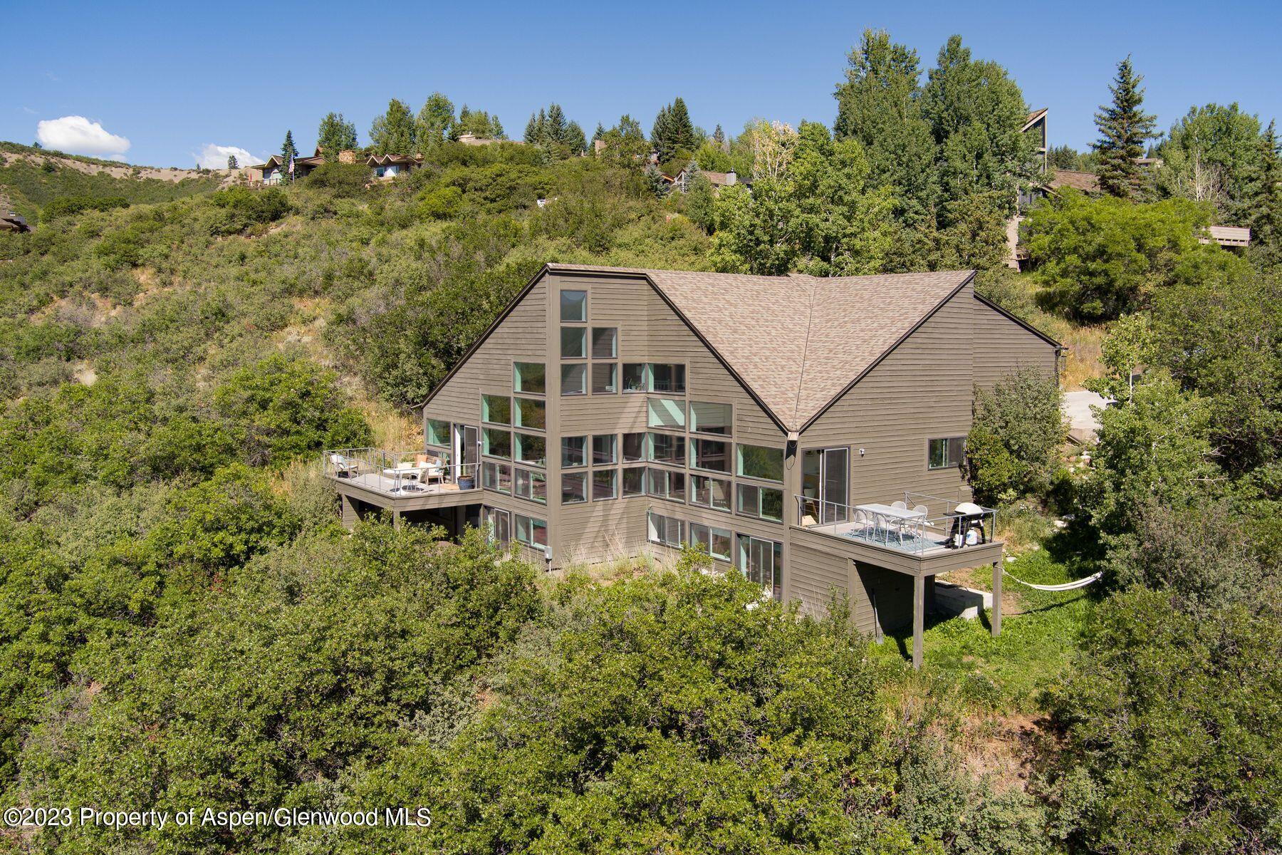 61 Oak Ridge Road Snowmass Village, CO 81615 - Photo 9 of 48 a aerial view of a house with a yard and trees in the background