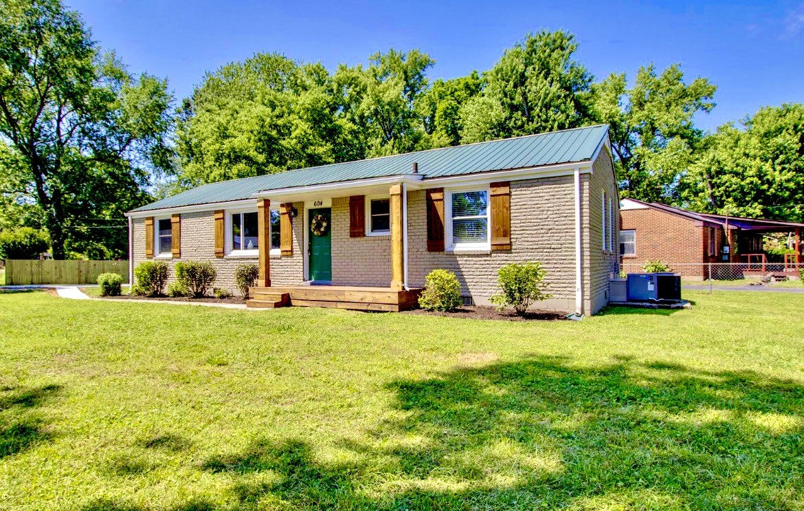 a front view of house with yard and green space