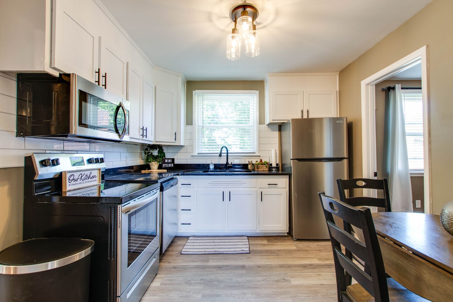 604 Cardinal Drive Murfreesboro, TN 37130 - Photo 9 of 16 a kitchen with a refrigerator a stove a sink dishwasher and white cabinets with wooden floor
