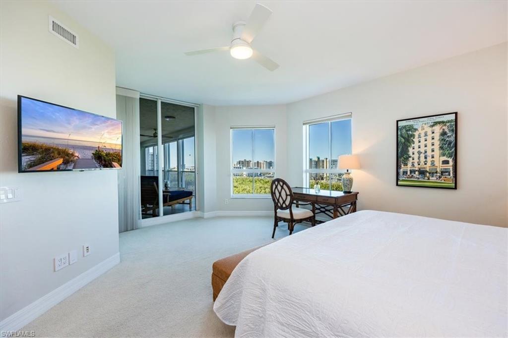 295 Grande Way, Unit 702 Naples, FL 34110 - Photo 14 of 31 a bedroom with a bed and a view of kitchen