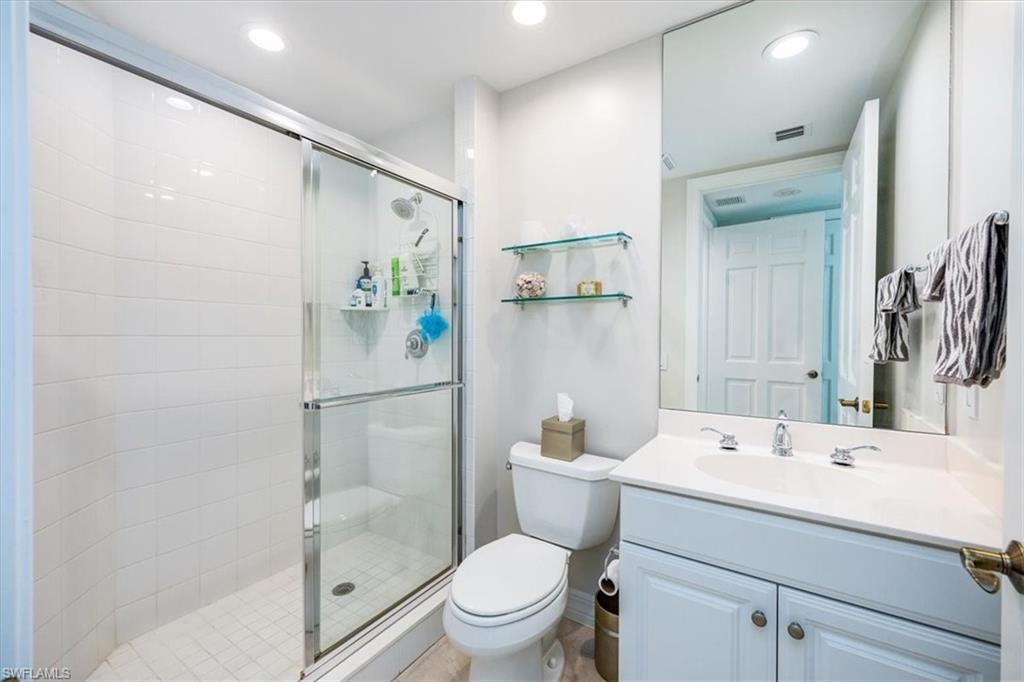 295 Grande Way, Unit 702 Naples, FL 34110 - Photo 18 of 31 a bathroom with a sink toilet and shower