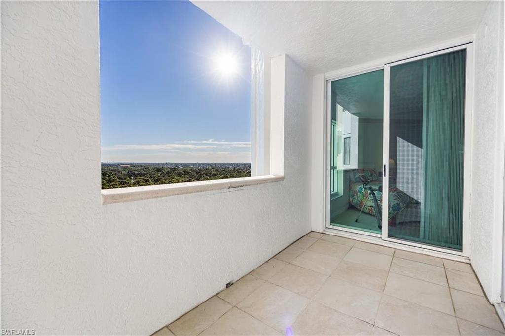295 Grande Way, Unit 702 Naples, FL 34110 - Photo 19 of 31 an empty room with window