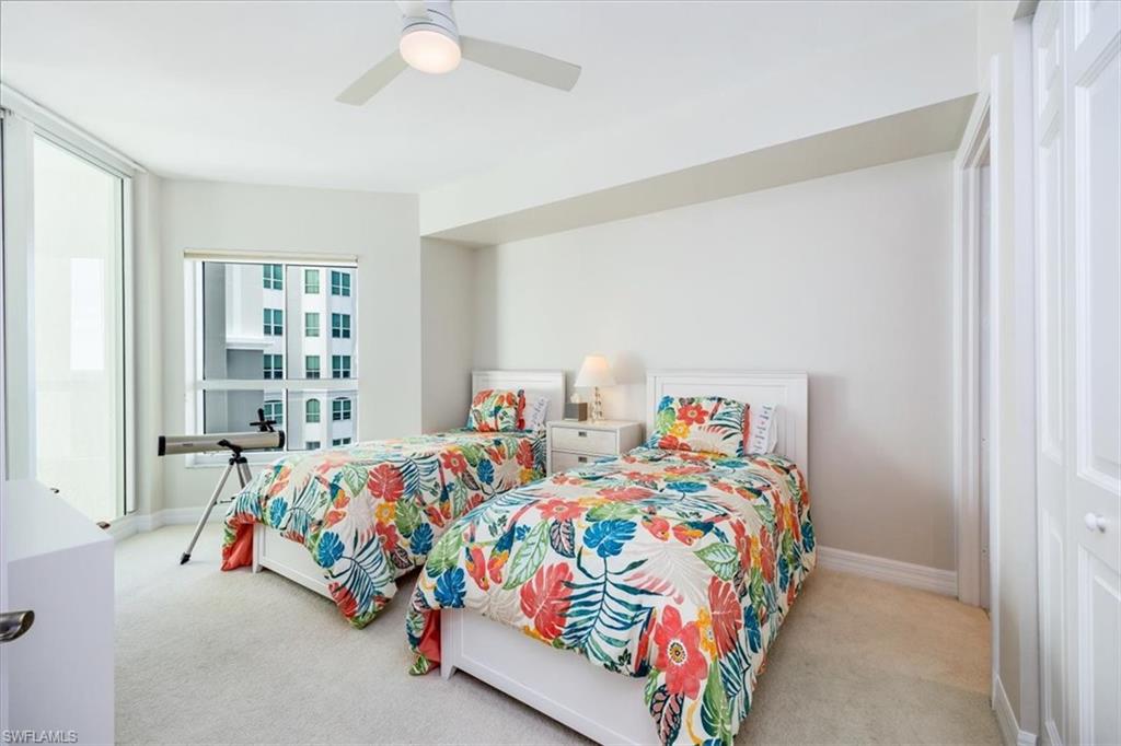 295 Grande Way, Unit 702 Naples, FL 34110 - Photo 20 of 31 a bedroom with two beds and a window