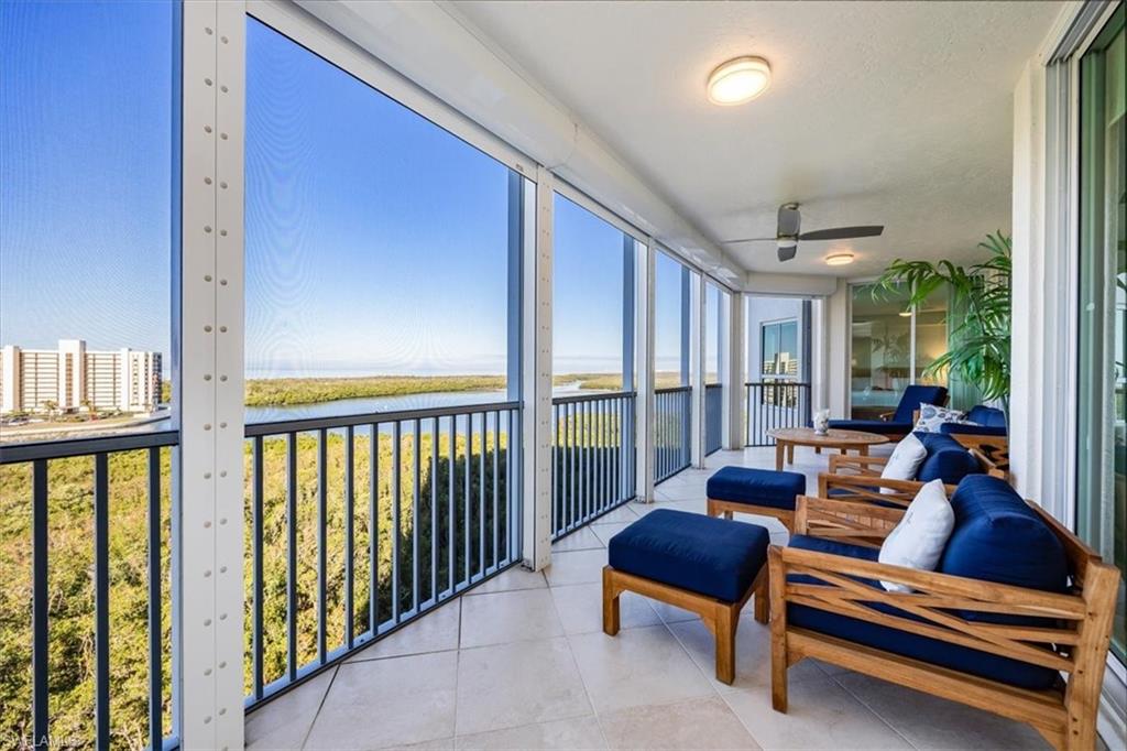 295 Grande Way, Unit 702 Naples, FL 34110 - Photo 26 of 31 a living room with furniture and a gate