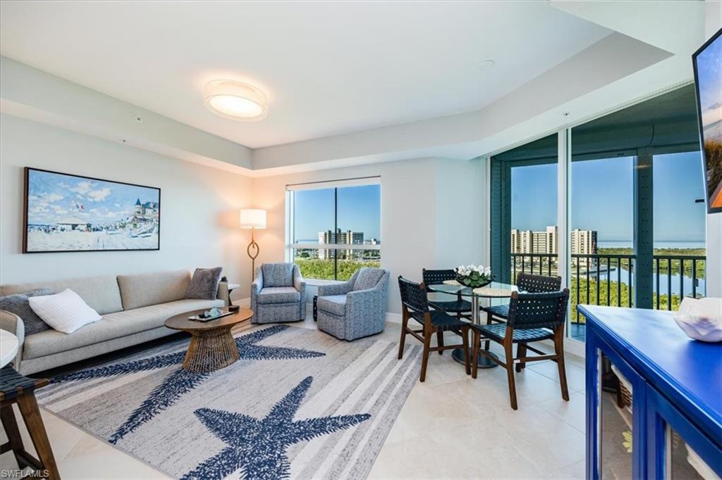 295 Grande Way, Unit 702 Naples, FL 34110 - Photo 8 of 31 a living room with furniture and a large window