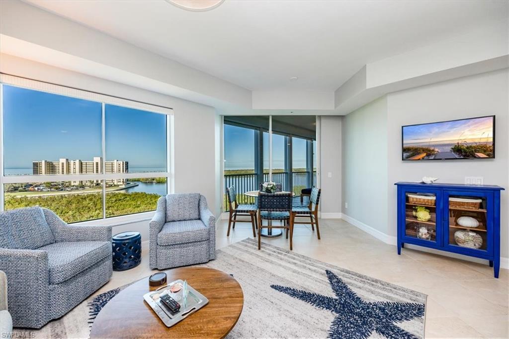 295 Grande Way, Unit 702 Naples, FL 34110 - Photo 10 of 31 a living room with furniture and a large window