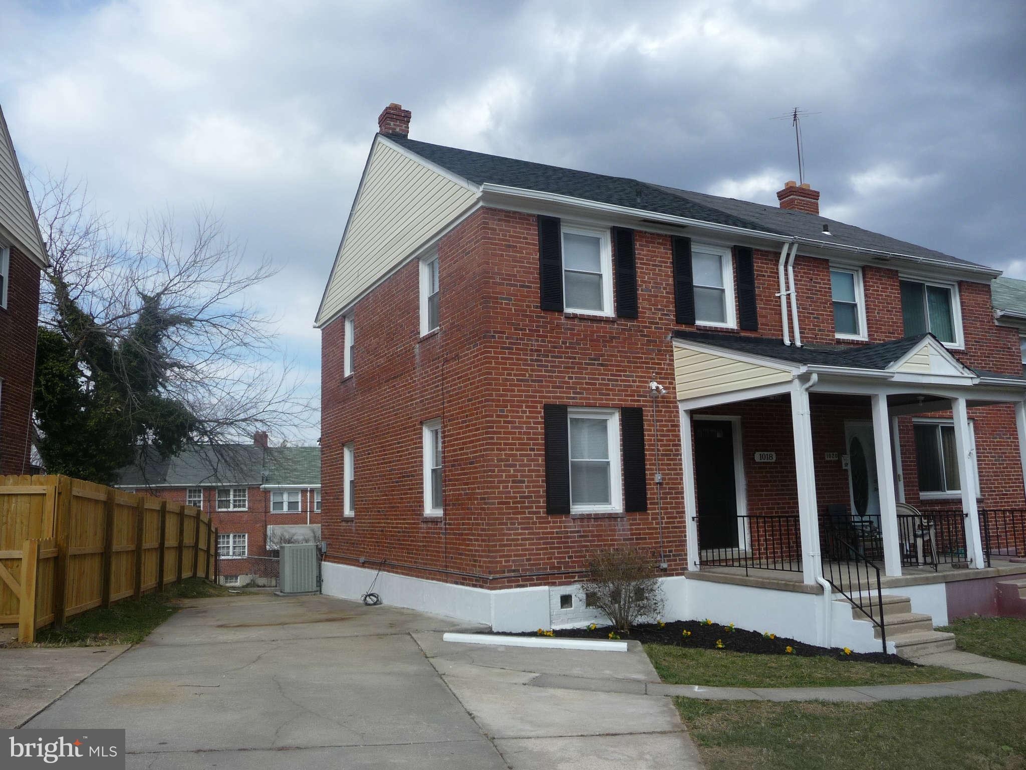 1018 Witherspoon Road Baltimore, MD 21212 - Photo 1 of 19 a front view of a house with a yard