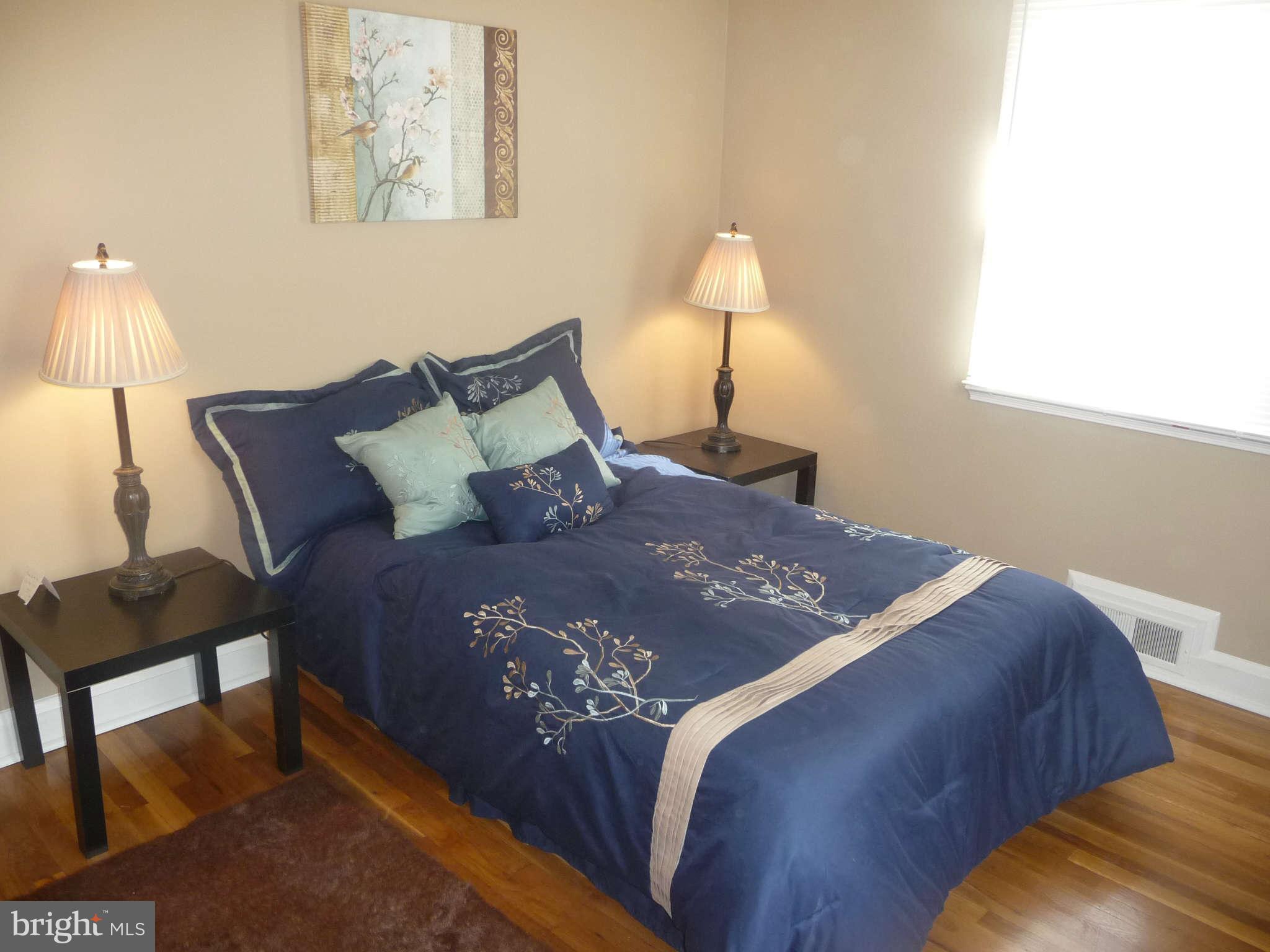1018 Witherspoon Road Baltimore, MD 21212 - Photo 11 of 19 a bed sitting in a bedroom next to a lamp