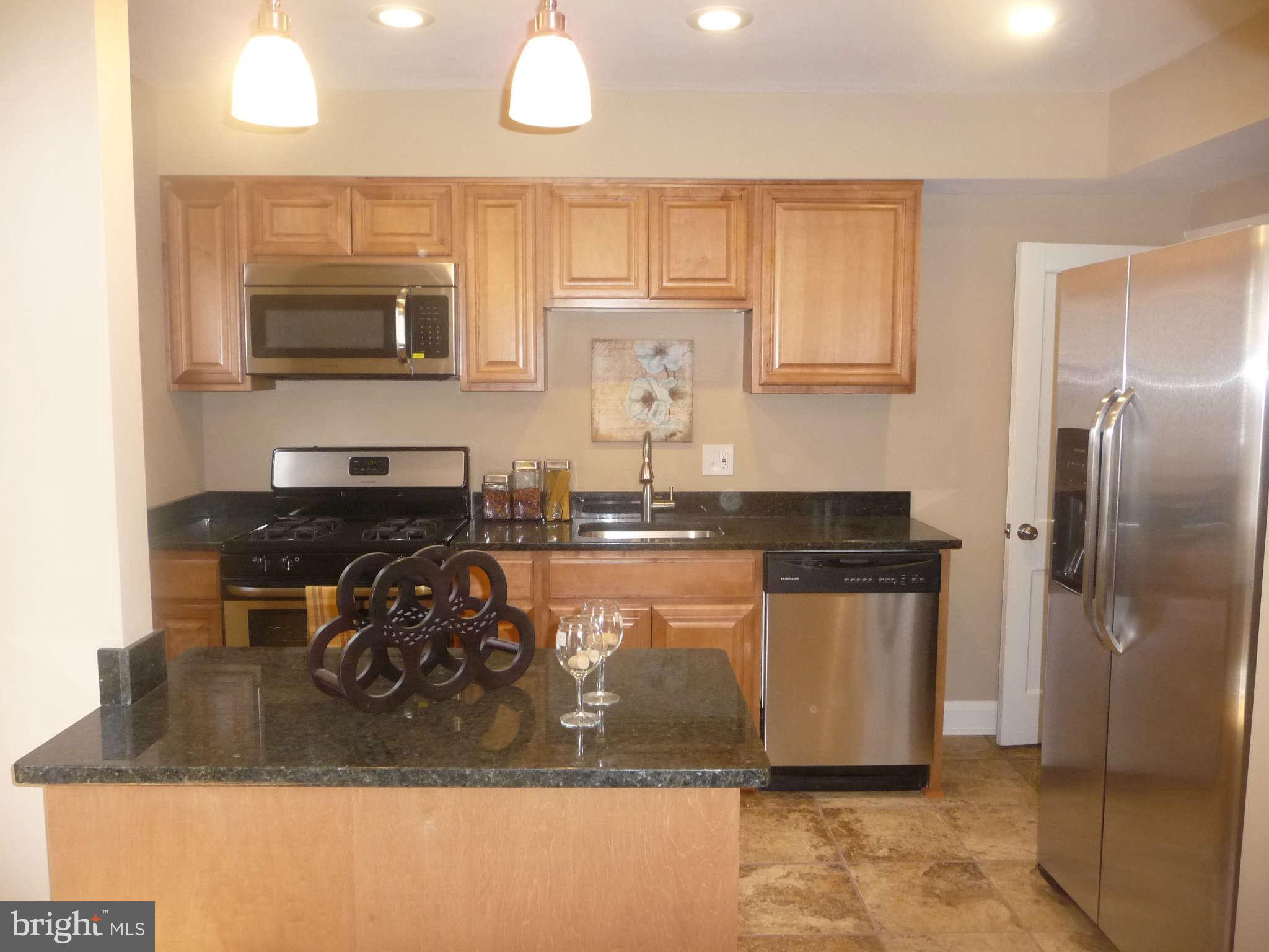 1018 Witherspoon Road Baltimore, MD 21212 - Photo 5 of 19 a kitchen with a refrigerator and a stove