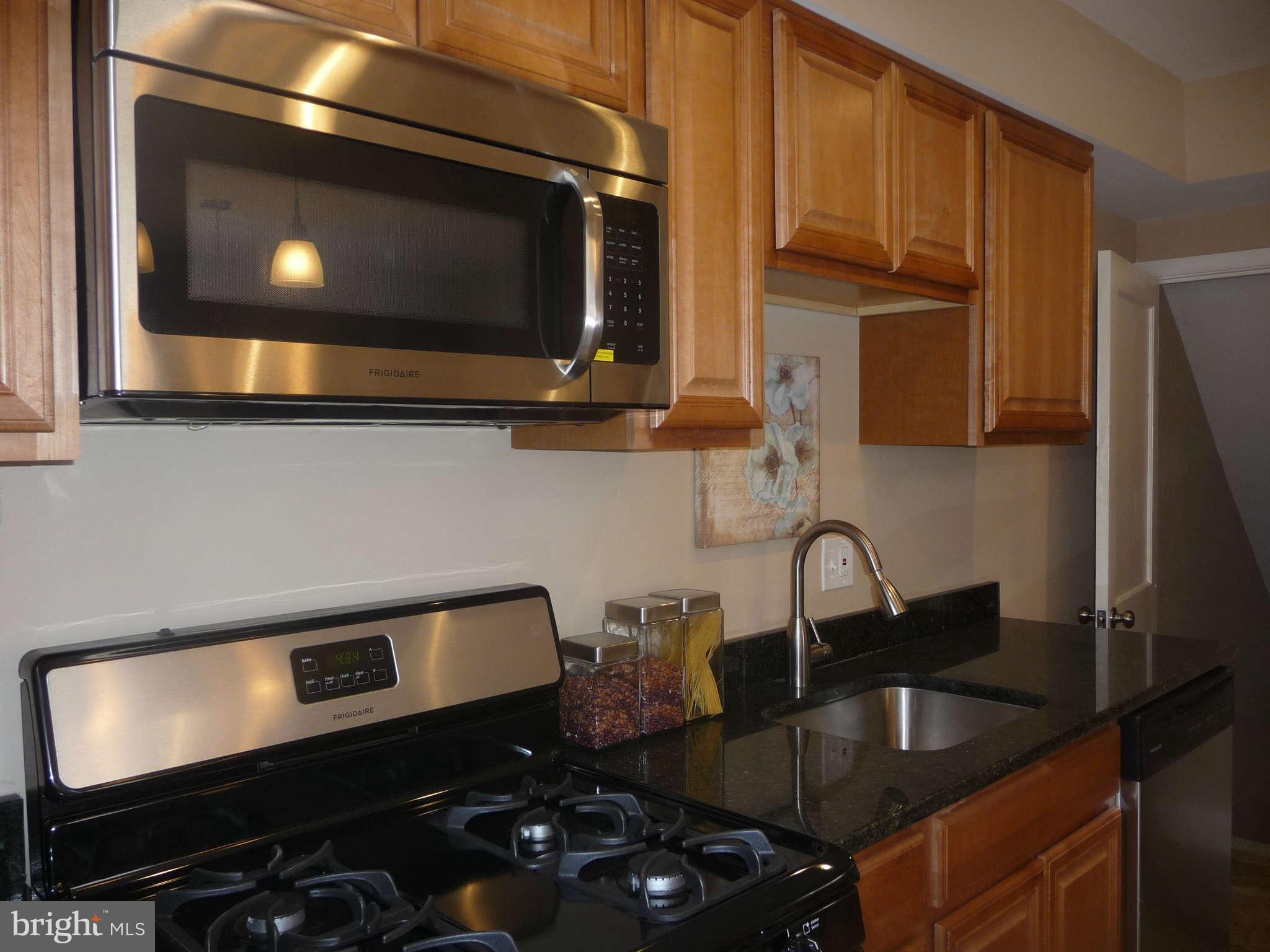 1018 Witherspoon Road Baltimore, MD 21212 - Photo 6 of 19 a kitchen with a sink stove and microwave
