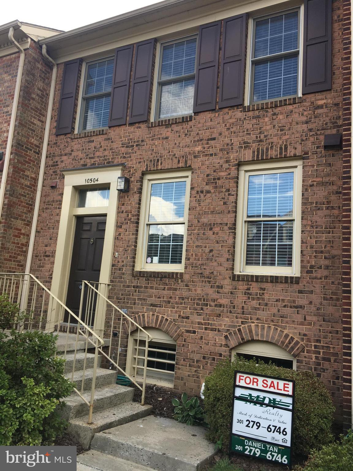 10504 Grove Ridge Place, Unit 48 Rockville, MD 20852 - Photo 1 of 30 a front view of a building with brick walls