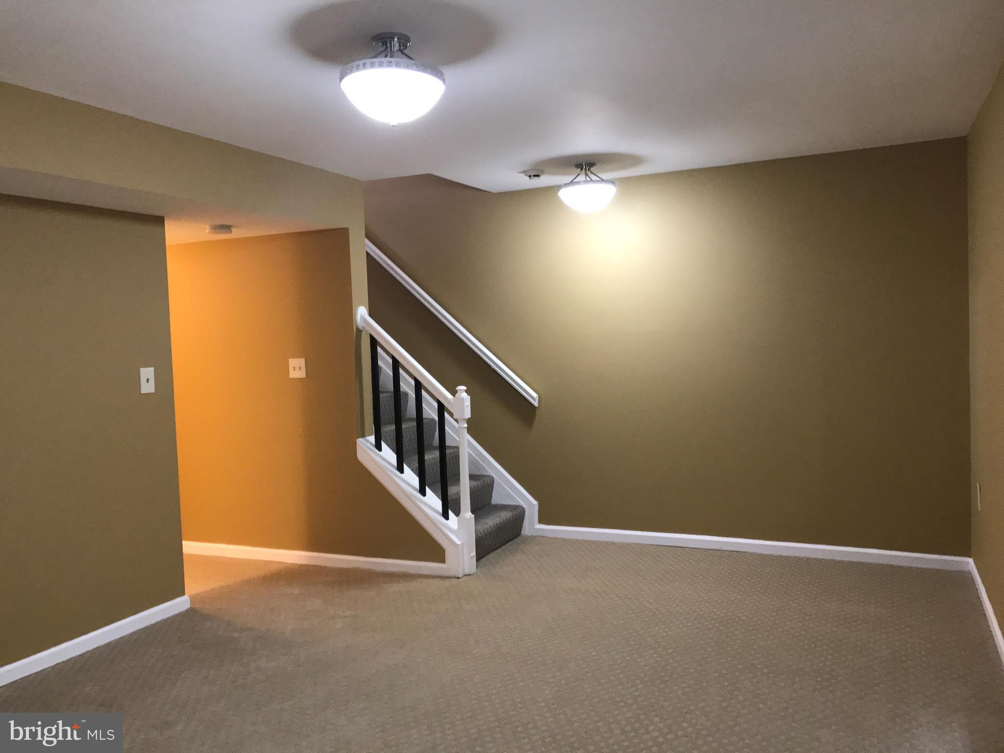 10504 Grove Ridge Place, Unit 48 Rockville, MD 20852 - Photo 14 of 30 a view of an empty room with stairs