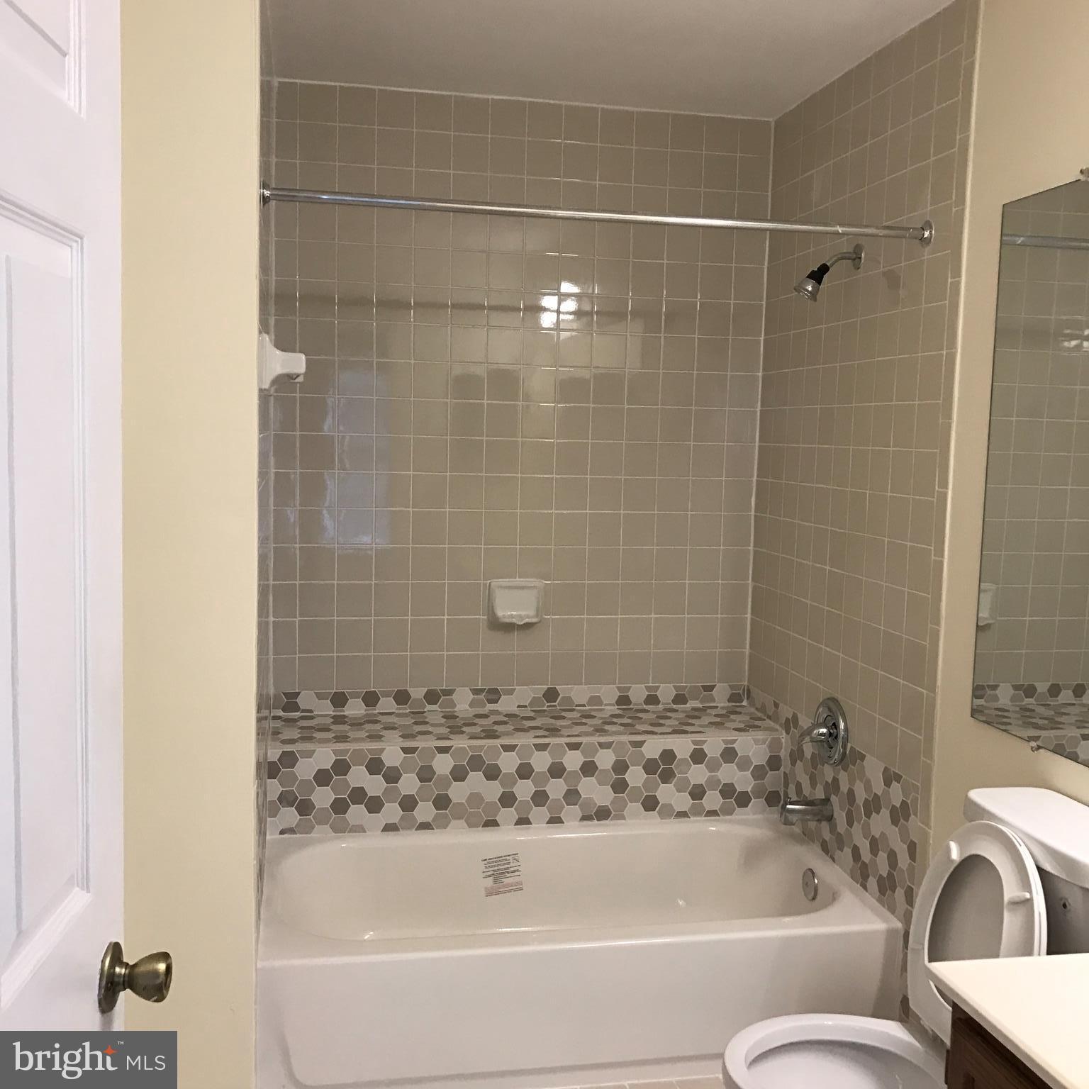10504 Grove Ridge Place, Unit 48 Rockville, MD 20852 - Photo 18 of 30 a bathroom with a bathtub and a toilet
