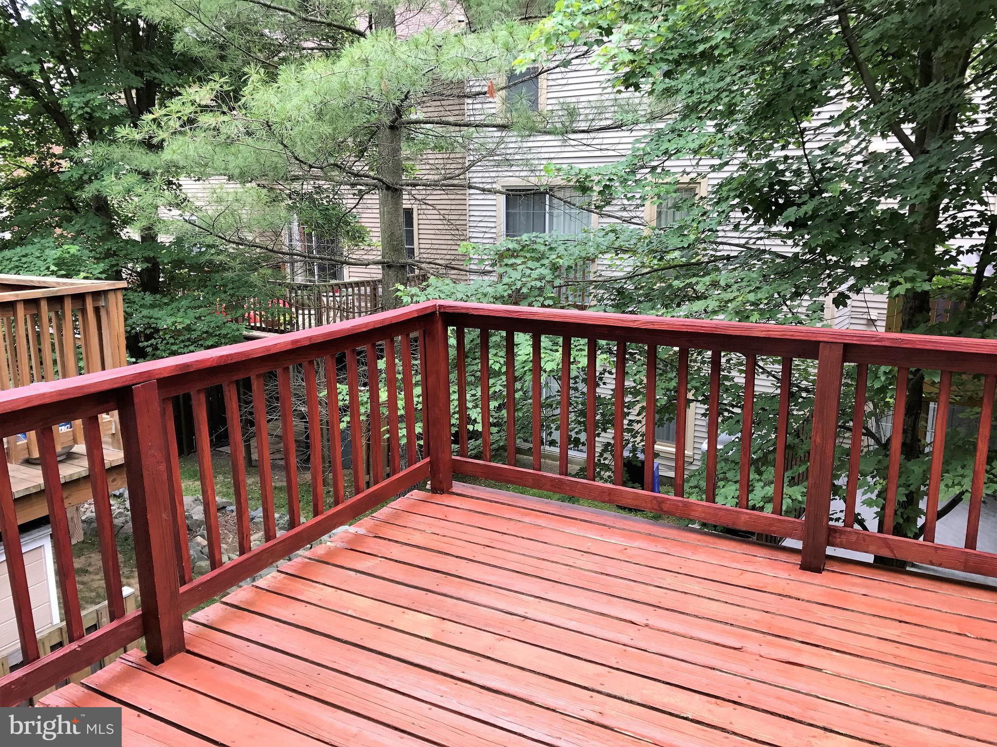 10504 Grove Ridge Place, Unit 48 Rockville, MD 20852 - Photo 30 of 30 a balcony with wooden floor and fence
