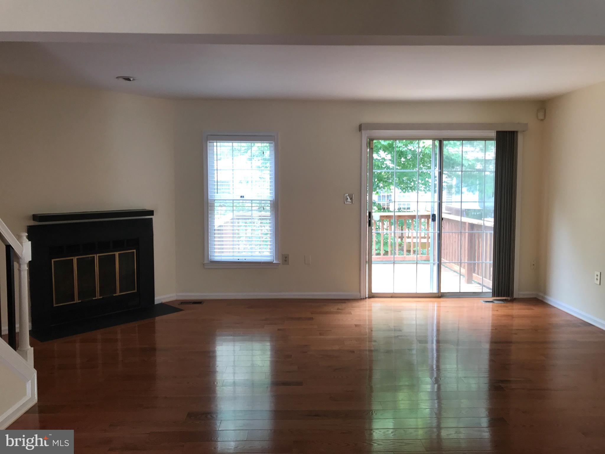 10504 Grove Ridge Place, Unit 48 Rockville, MD 20852 - Photo 9 of 30 a view of an empty room with wooden floor and a window
