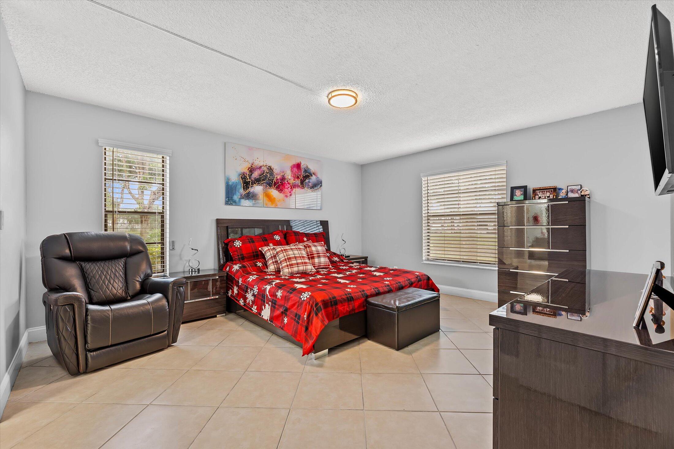 23466 Lyons Road, Unit 501 Boca Raton, FL 33428 - Photo 15 of 40 a bedroom with a bed and a couch