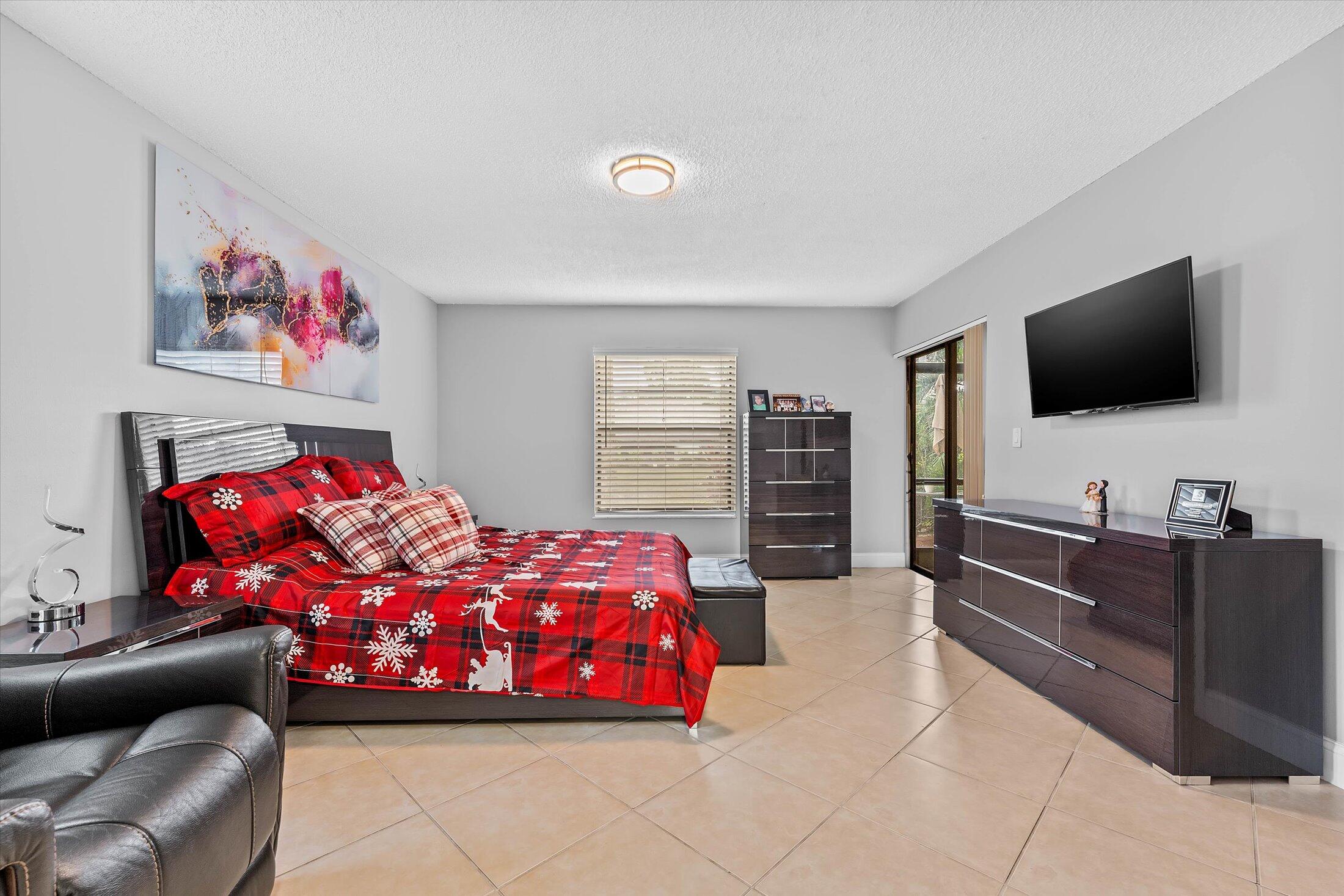 23466 Lyons Road, Unit 501 Boca Raton, FL 33428 - Photo 16 of 40 a bedroom with a bed and furniture