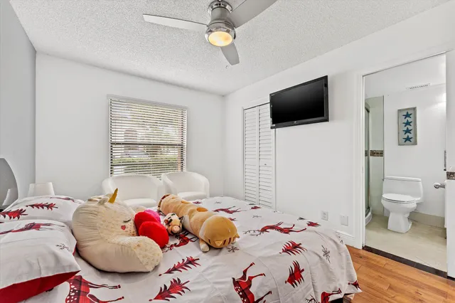 a bedroom with a bed and a tv