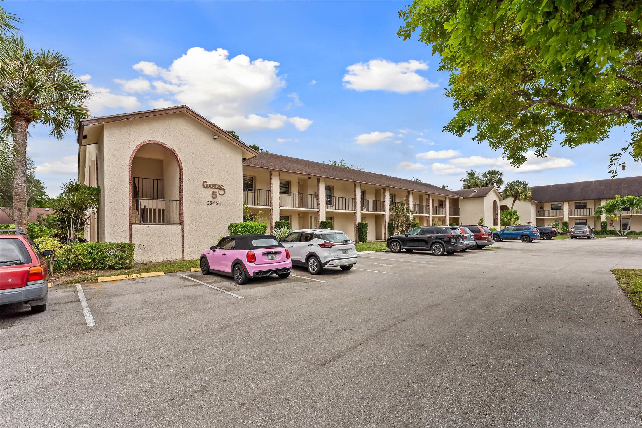 23466 Lyons Road, Unit 501 Boca Raton, FL 33428 - Photo 2 of 40 a front view of a house with parking
