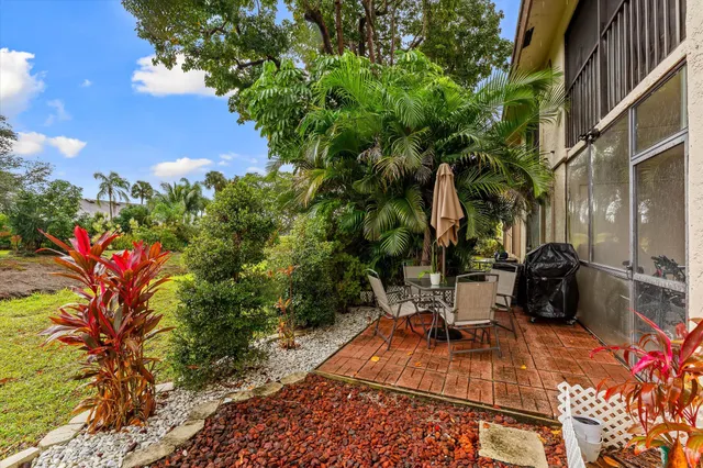 a view of a patio with table and chairs and potted plants