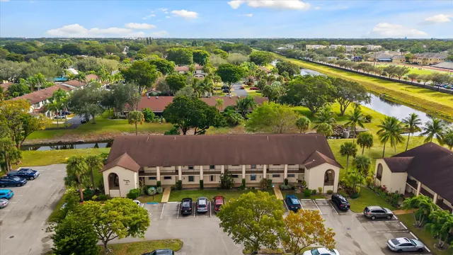 an aerial view of residential houses with outdoor space and swimming pool