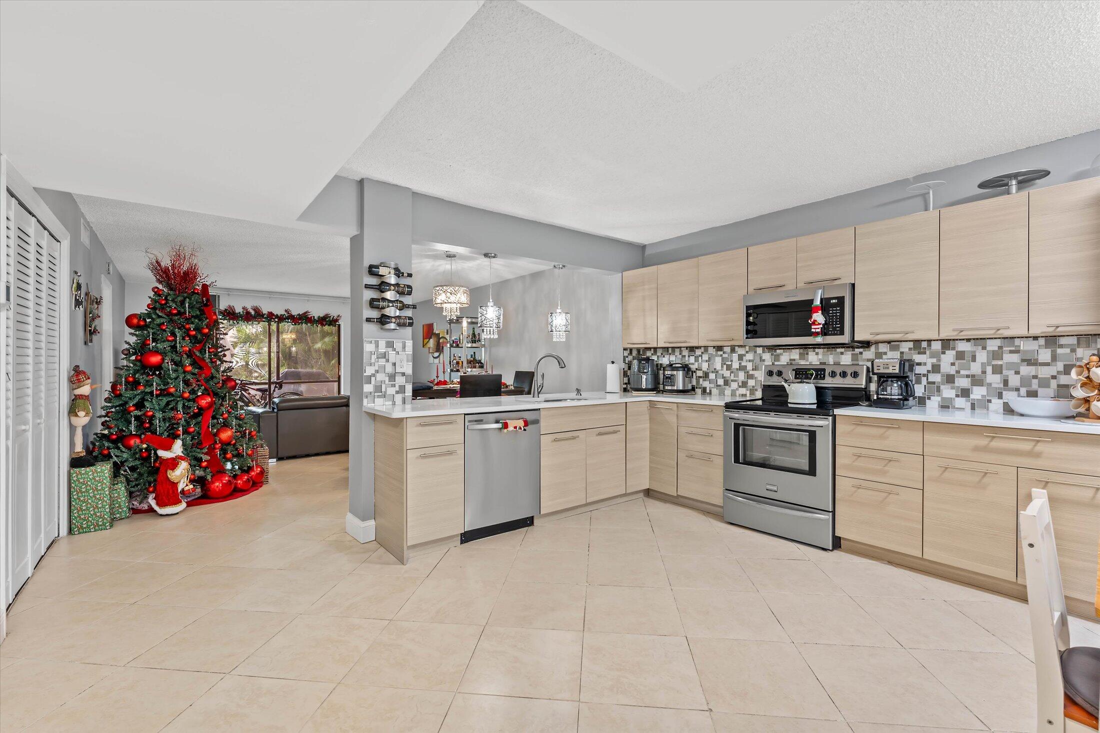 23466 Lyons Road, Unit 501 Boca Raton, FL 33428 - Photo 7 of 40 a kitchen with cabinets and window