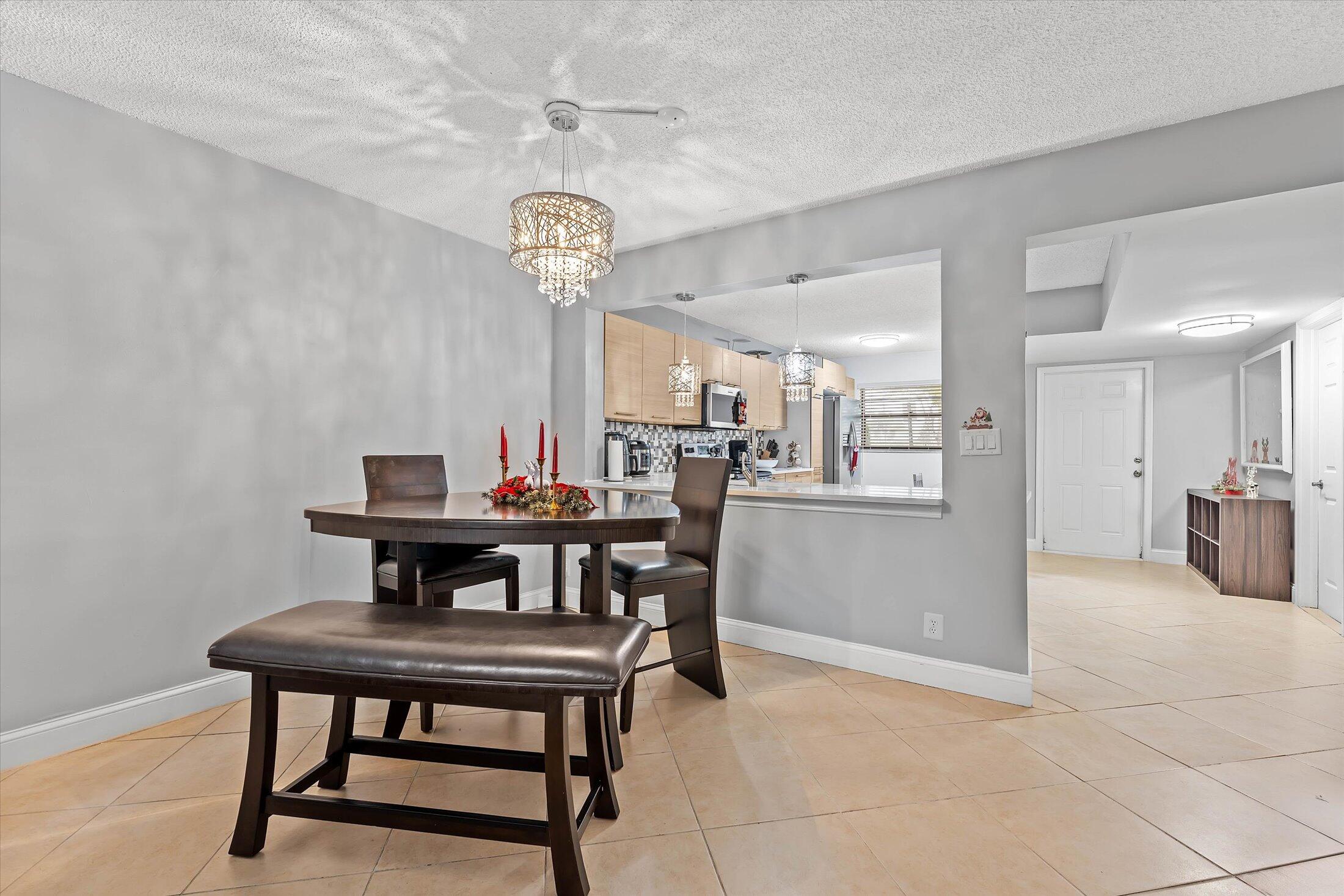 23466 Lyons Road, Unit 501 Boca Raton, FL 33428 - Photo 8 of 40 a view of a dining room with furniture
