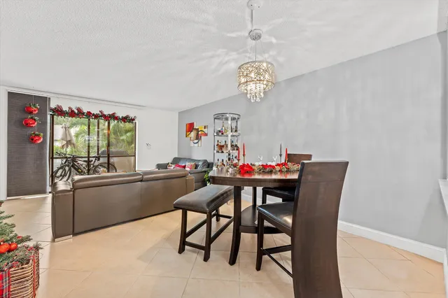 a view of a dining room with furniture a chandelier and wooden floor