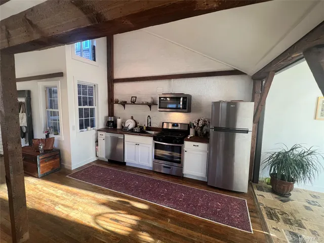 a kitchen with refrigerator and microwave